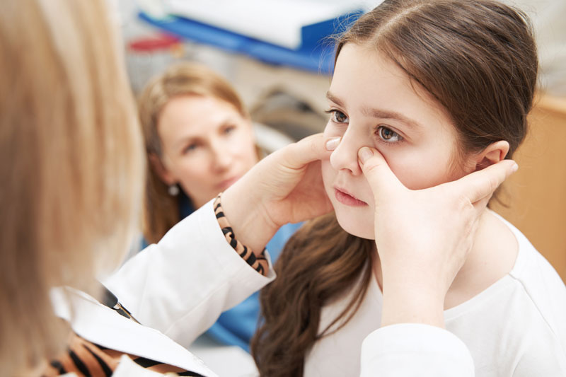 Young girl being examined by female doctor