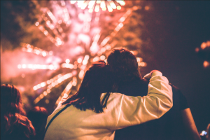 man and woman watching fireworks on the Fourth of July